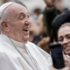 Pope Francis smiles leaving an event